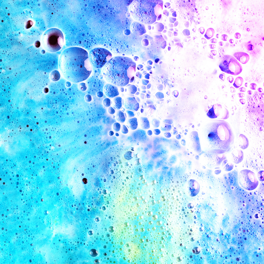 blue and pink bath bomb fizzing and melting in water
